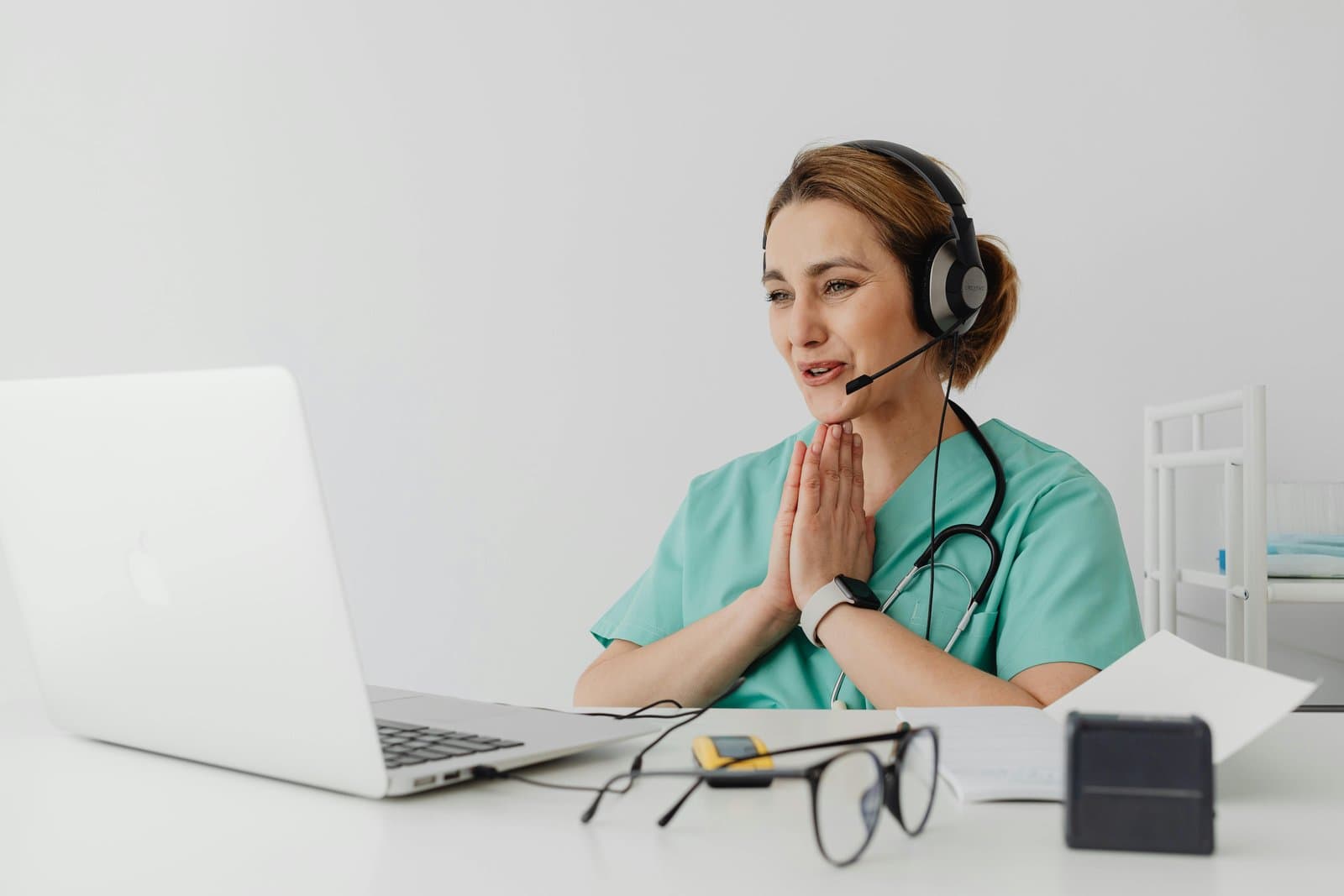 A doctor conducting a telemedicine consultation on a laptop
